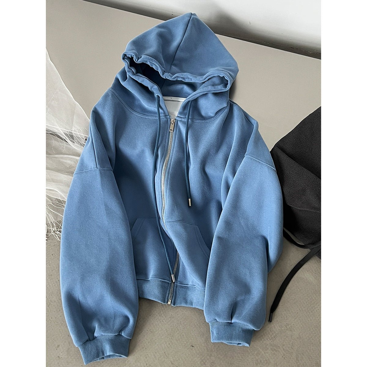 Women’s light blue zip-up hooded sweatshirt with front zipper and drawstring hood
