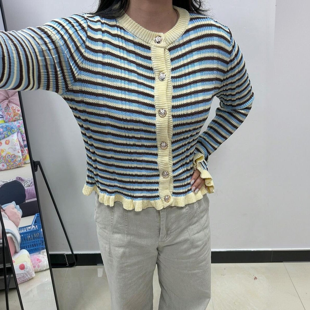 Striped ribbed cardigan with yellow button-front, round neck, lettuce hem; multicolor blue/cream stripes.