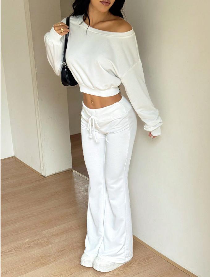 White off-shoulder cropped sweatshirt with long sleeves and drawstring flared pants