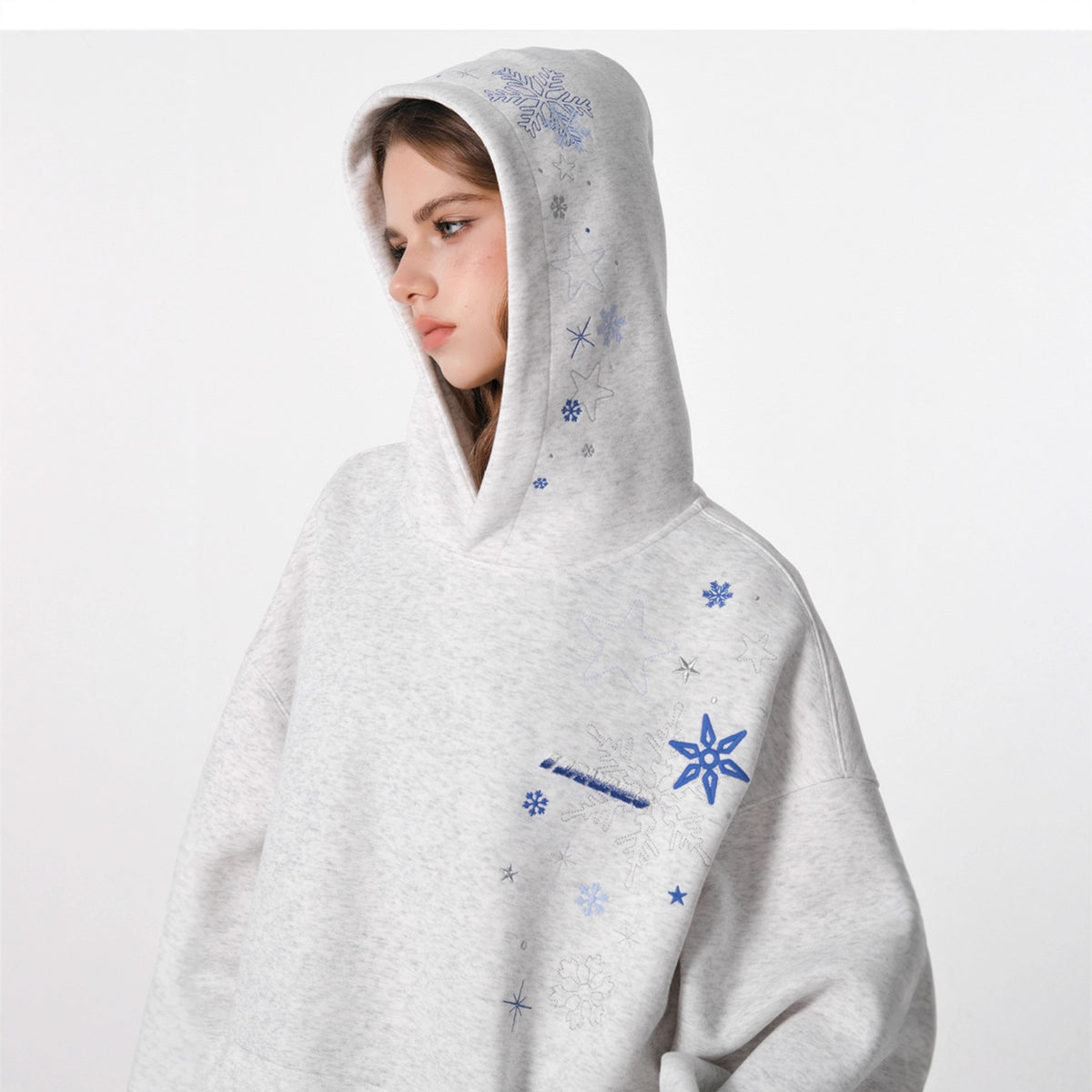 Light gray cotton hoodie with hood up and blue snowflake embroidery detail on front