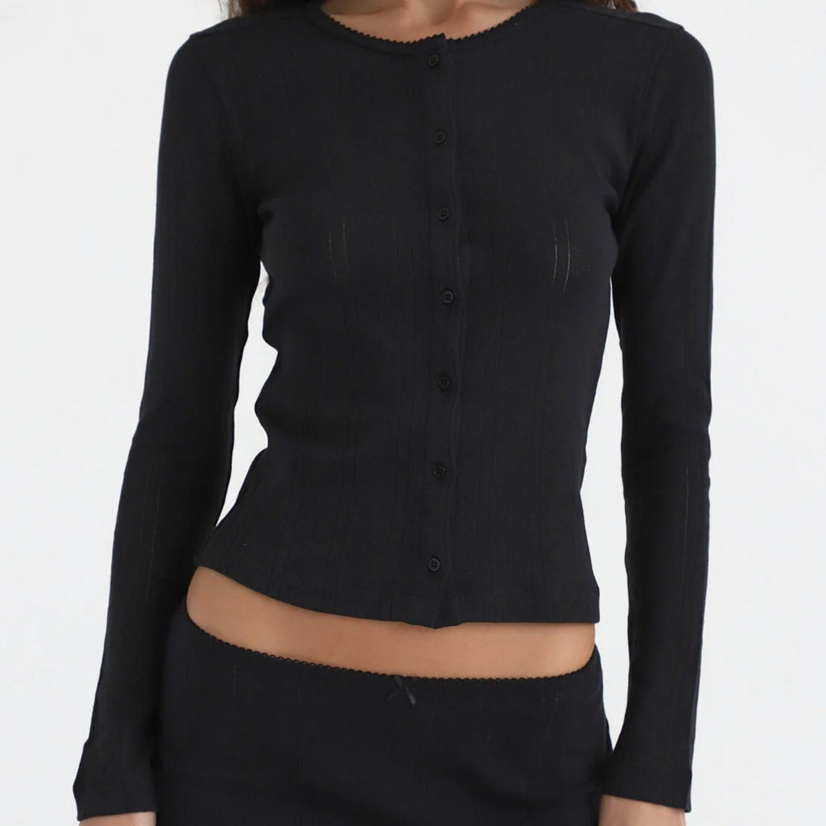Black thin knit cardigan, round neck, long sleeves, button front with scalloped hem