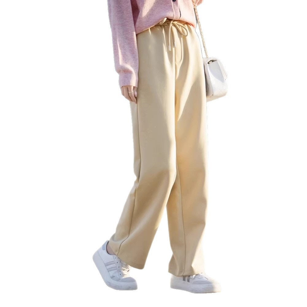 Women’s pale yellow wide-leg pants with elastic waist drawcord and relaxed straight legs