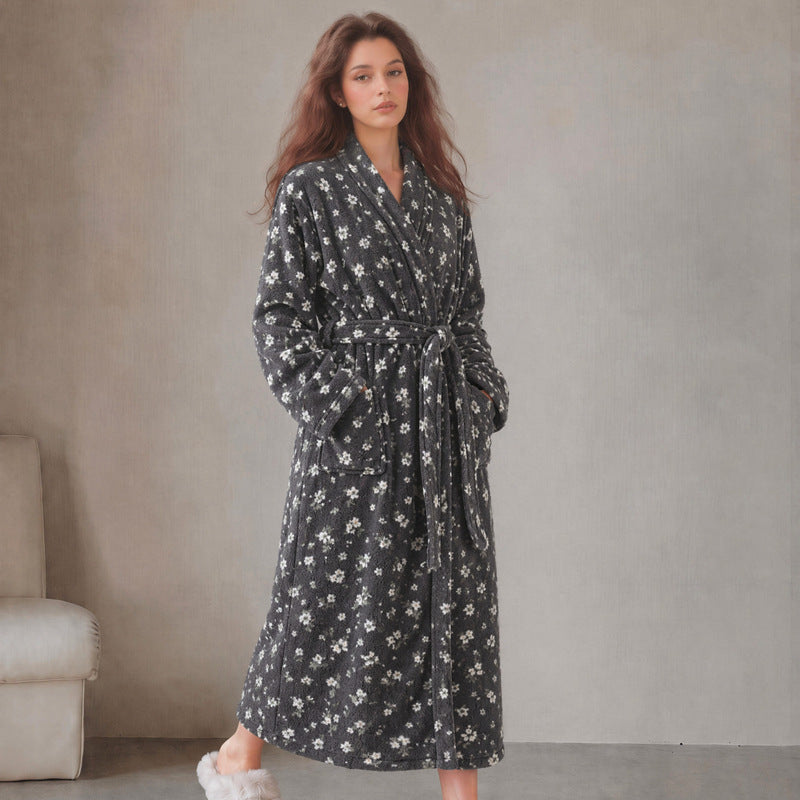 Women’s long flannel bathrobe in black with small white floral print, tie belt and pockets