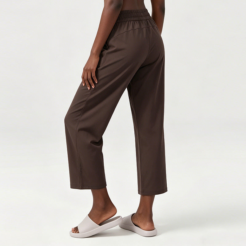 Women’s wide-leg sweatpants with elastic waistband, dark brown fabric, side pocket detail.