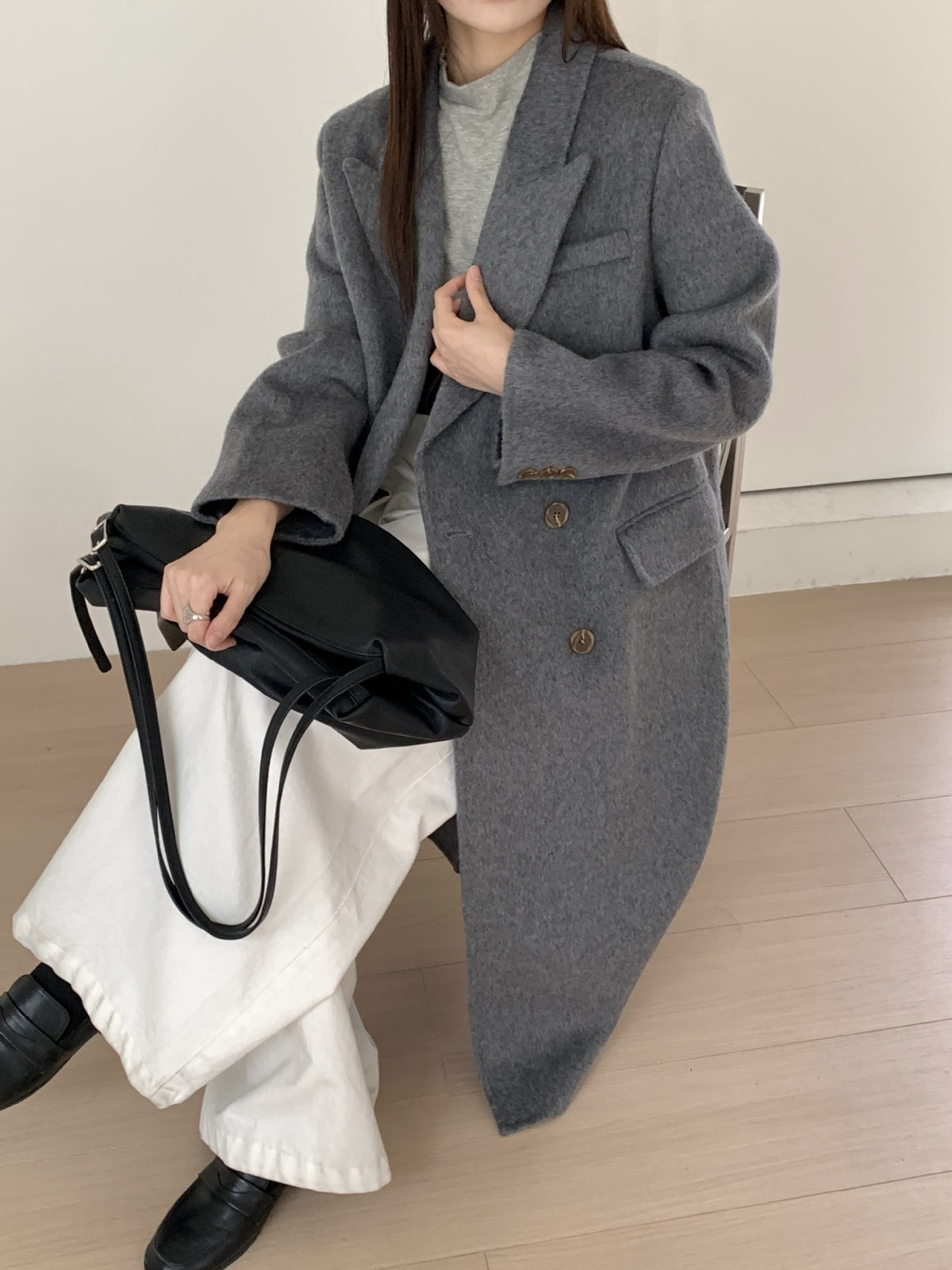 Charcoal-gray long double-breasted cashmere coat with chest pocket and gold-tone buttons