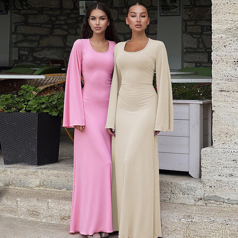 Ribbed knit maxi dress in pink and beige, scoop neck, long bell sleeves, fitted column