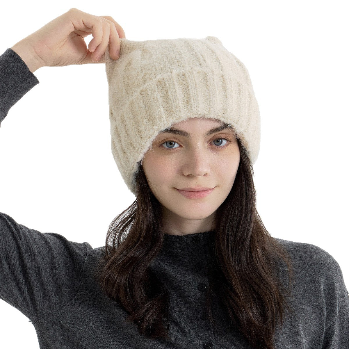 Beige cat-ear knit beanie close-up with ribbed knit texture and rounded top