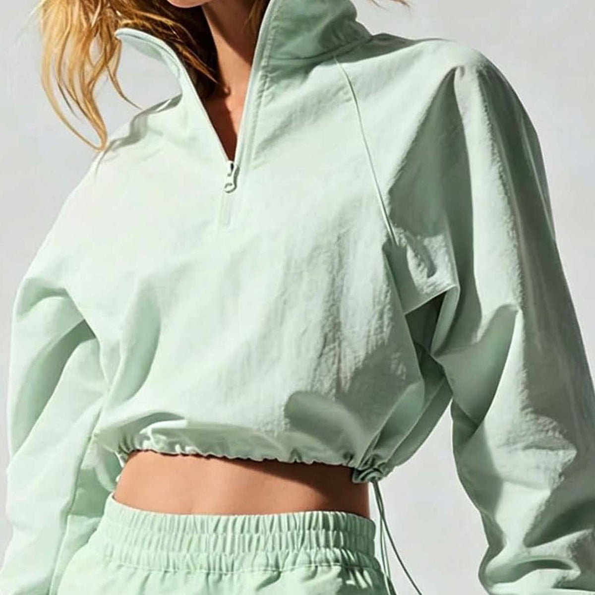 Mint cropped quarter-zip wind jacket with drawstring hem and elastic cuffs