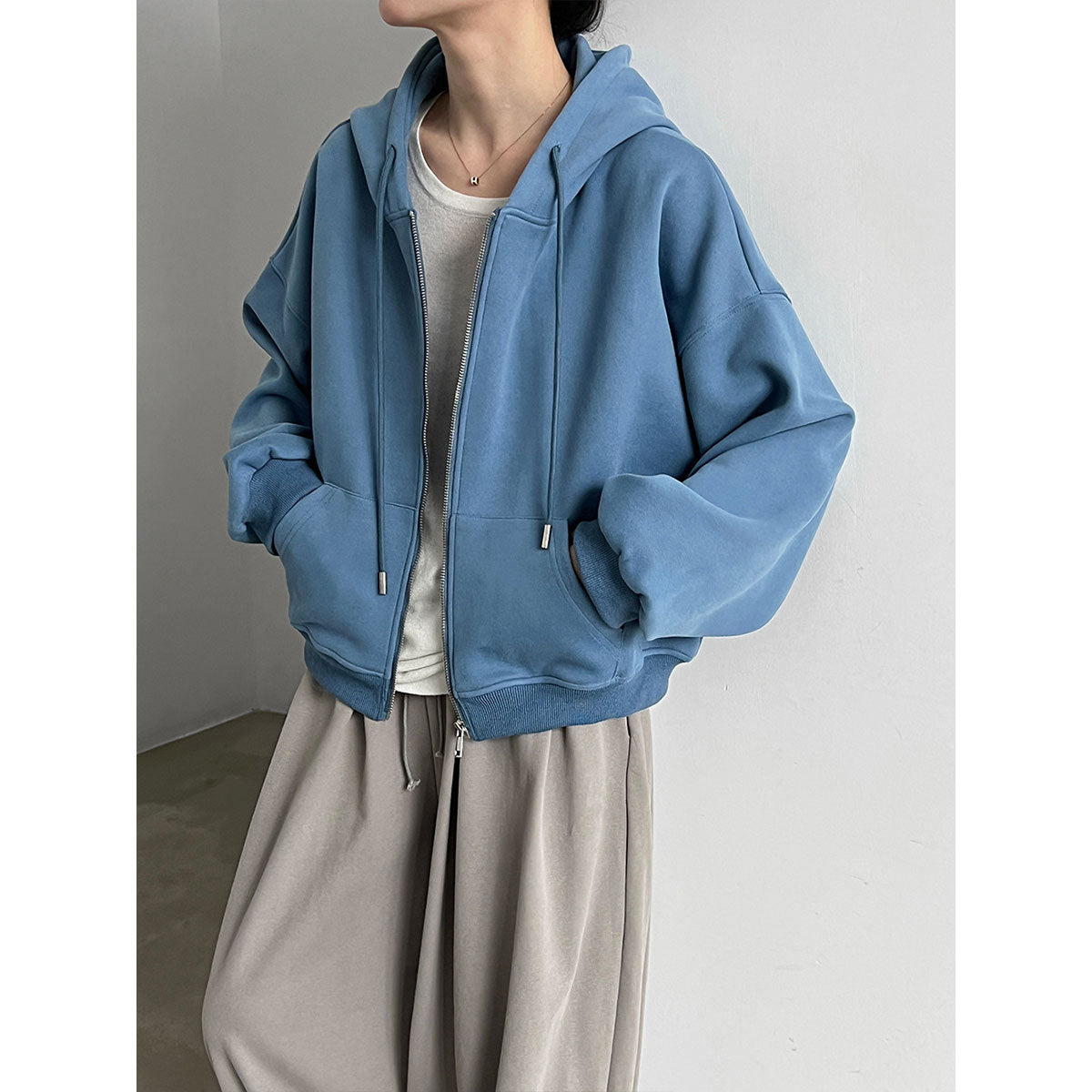 Women’s light blue zip-up hooded sweatshirt with drawstring hood and kangaroo pockets