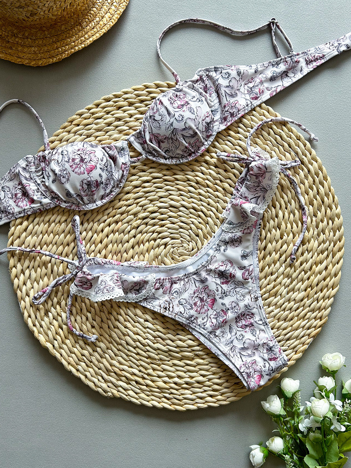 Violet baroque-print ruffle-trim balconette top and tie-side bikini bottoms, flat lay