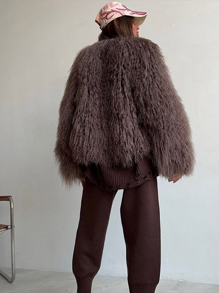 Brown short faux fur coat with long sleeves, shaggy texture, rear view