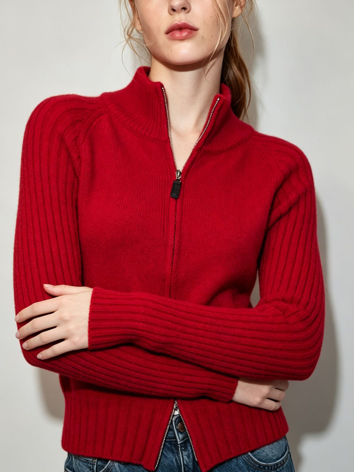 Women's red ribbed knit zip-up sweater jacket with stand collar and front zipper.