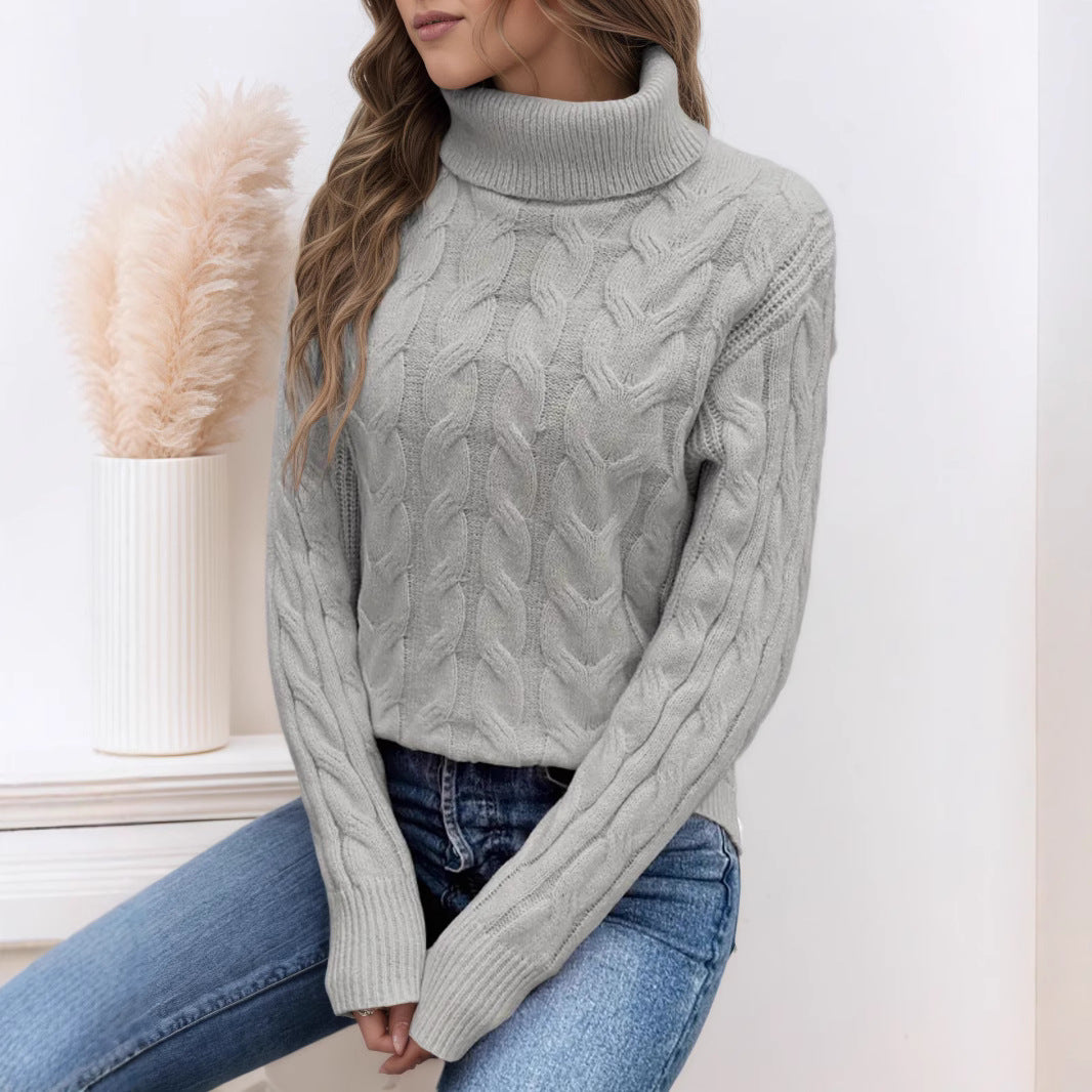Grey knit turtleneck sweater with long sleeves and cable twist texture