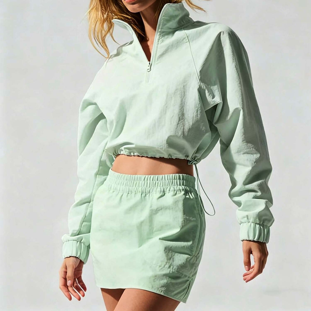 Women’s mint green half-zip jacket and mini skirt set with elastic waist