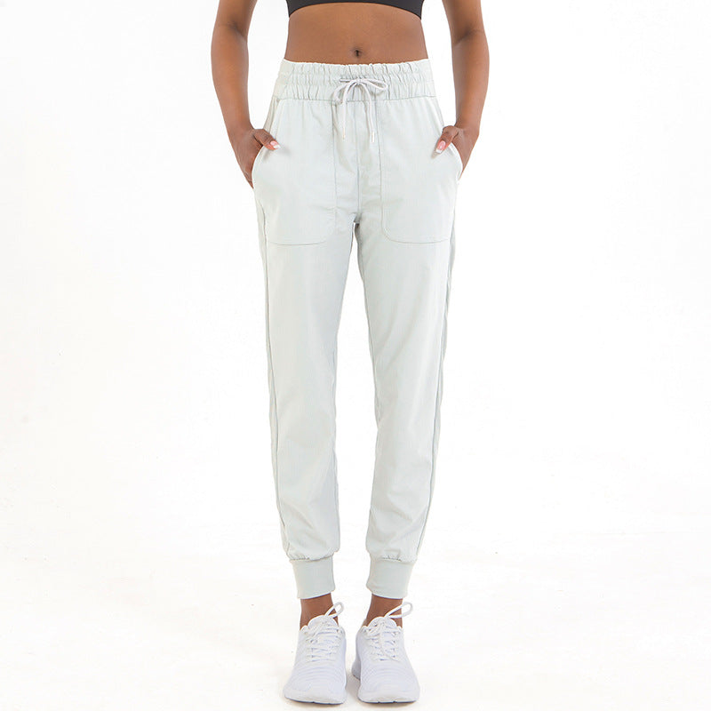 Light cream jogger pants with elastic drawstring waistband and ankle cuffs