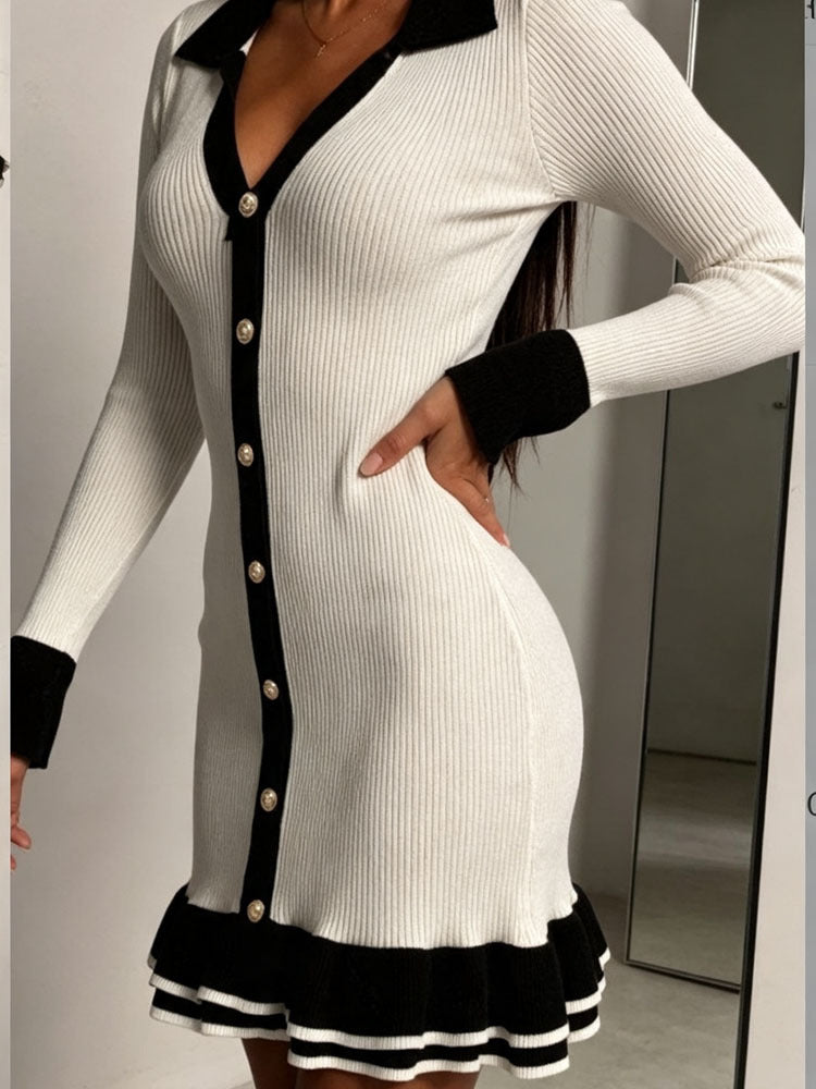 White knit mini dress with black trim, long sleeves, button front, ruffle hem detail