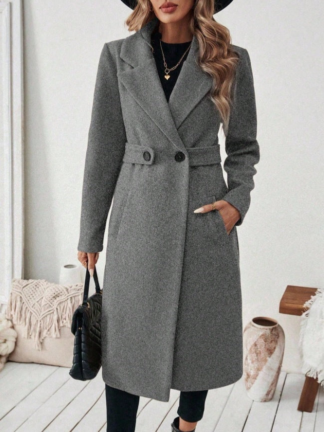 Gray wool long double-breasted coat with notched lapels, waist belt, and flap pockets.