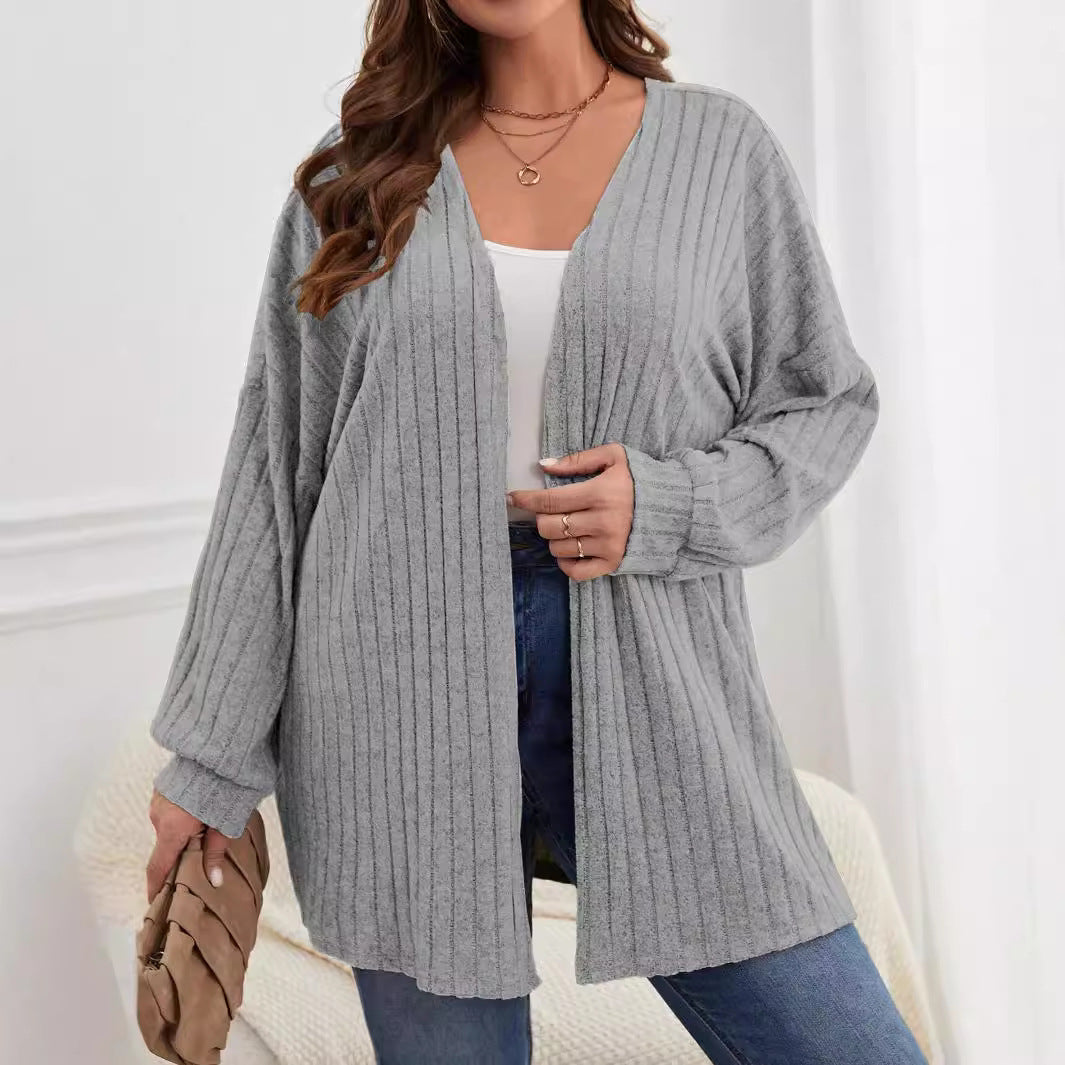 Grey plus-size knitted long-sleeve jacket with ribbed texture, open front, mid-length.