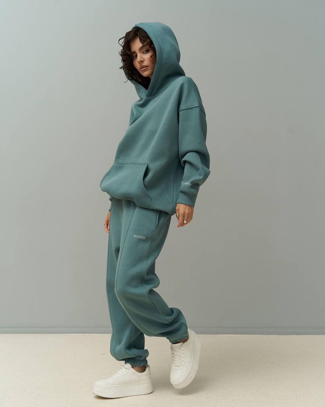 Teal hooded sweatshirt and matching jogger pants set with relaxed fit
