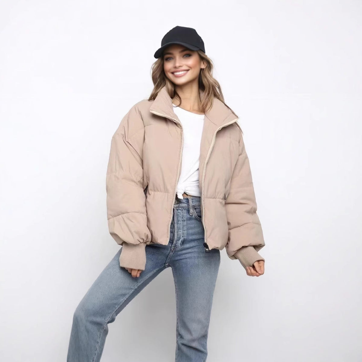 Short beige puffer jacket with full zip, stand collar, and ribbed cuffs