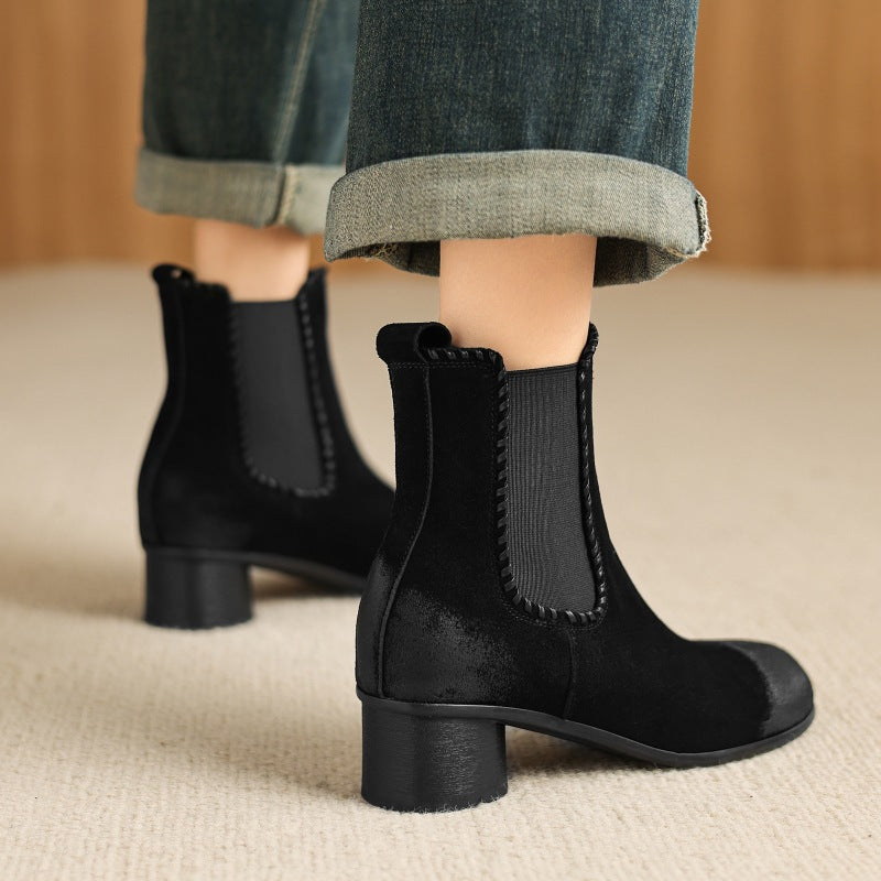 Black suede Chelsea ankle boot with round toe, thick heel, elastic side gore