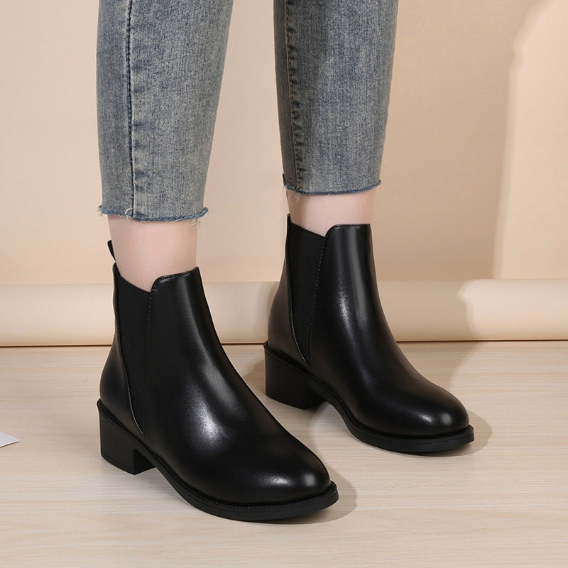 Black ankle chelsea boots with chunky heel and elastic side panels.