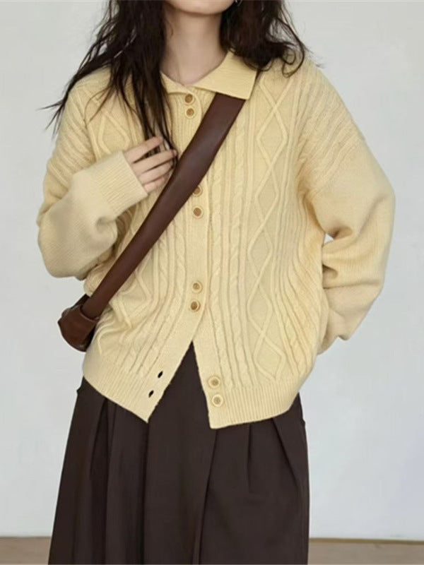 Pale yellow cable-knit cardigan with a pointed collar, buttons and relaxed sleeves