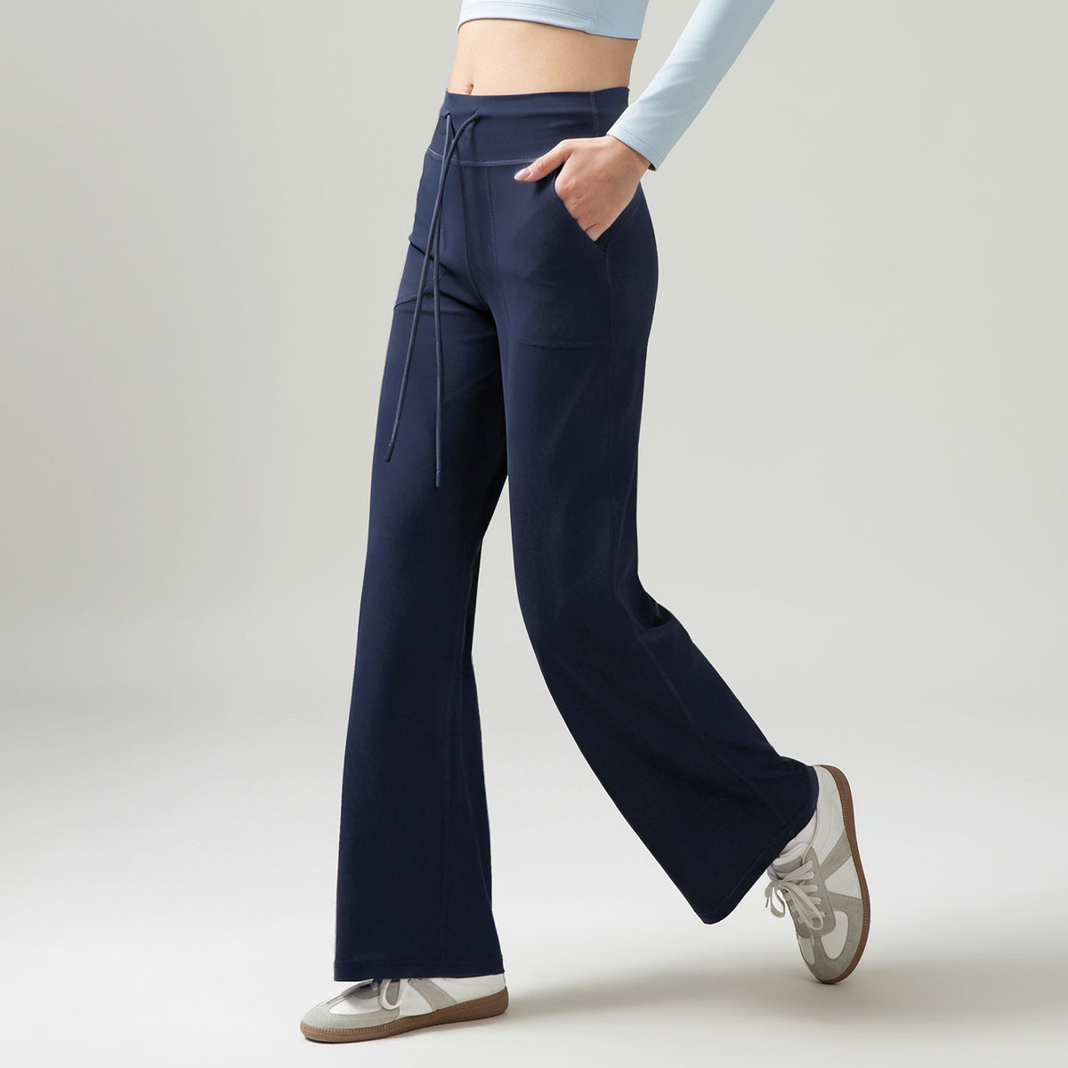 Women’s high-waisted wide-leg pants with drape, navy blue, side drawstring ties and pockets.