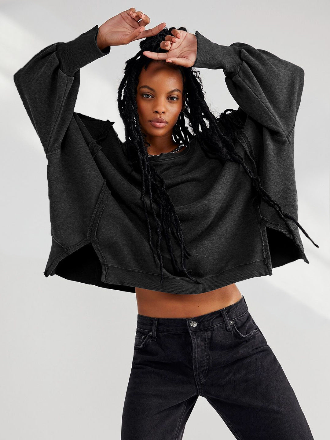 Dark charcoal cropped sweatshirt with a crew neck and oversized long sleeves