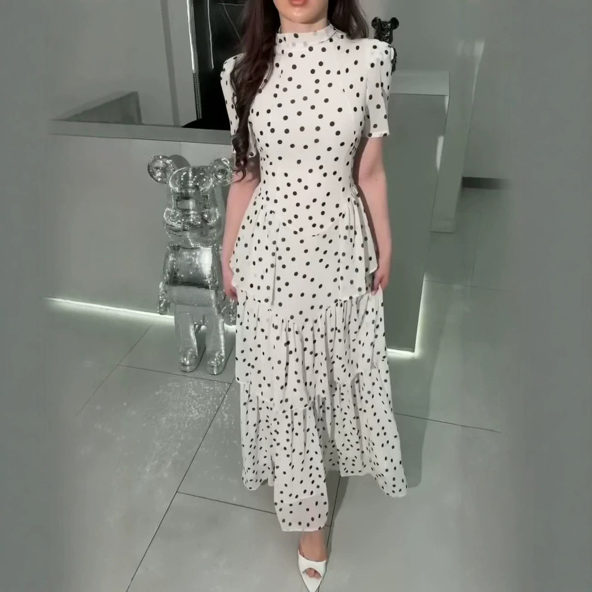 White polka dot high-neck maxi dress with puff sleeves and tiered ruffle layers