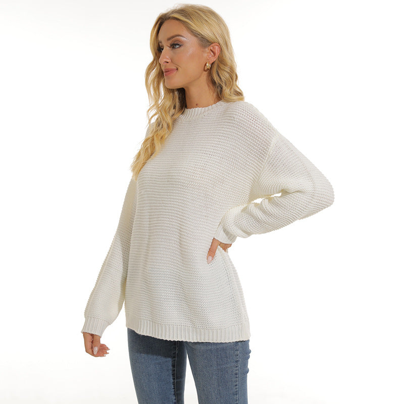 Women’s white knit pullover sweater with crew neck and long sleeves, ribbed hem and cuffs
