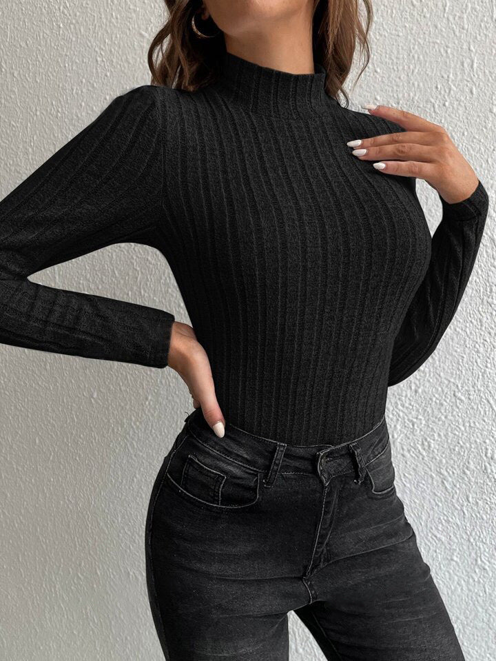 Black ribbed knit mock-neck long-sleeve fitted pullover sweater, folded sleeves