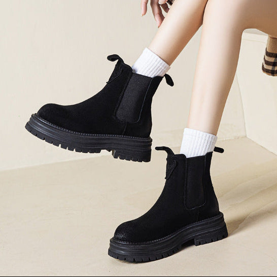 Women’s chunky platform chelsea boots in faux suede, black pair with white socks