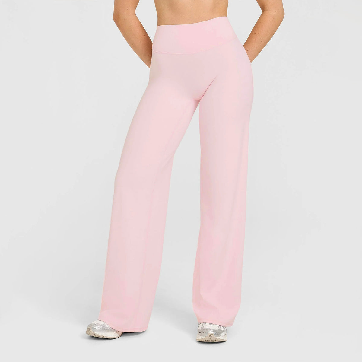 High-waisted straight-leg yoga pants in light nude pink, wide flare silhouette