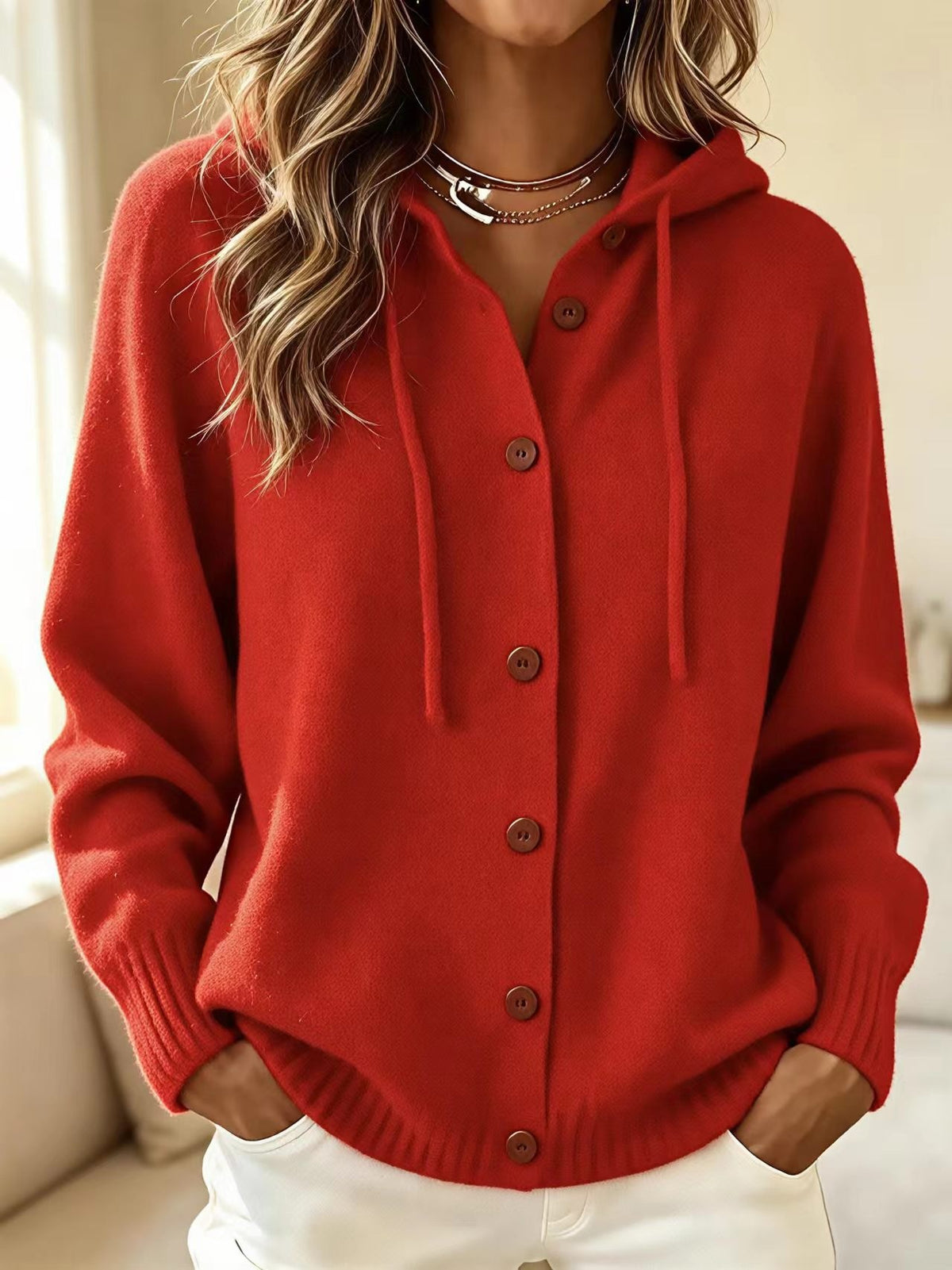 Red hooded knit cardigan sweater with front button placket and drawstring hood