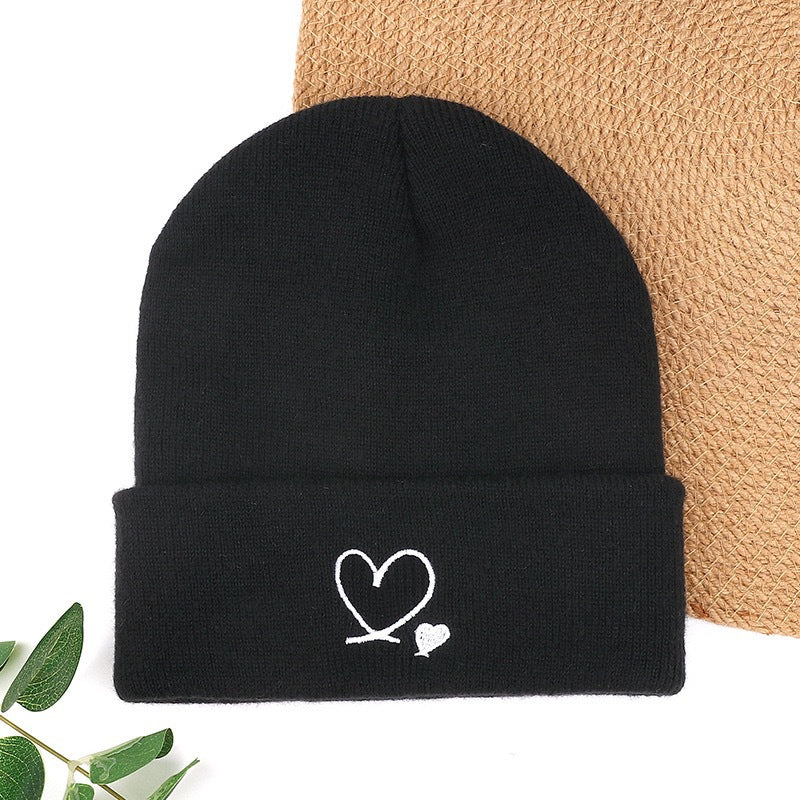 Black knit beanie with heart and small heart embroidery on cuff