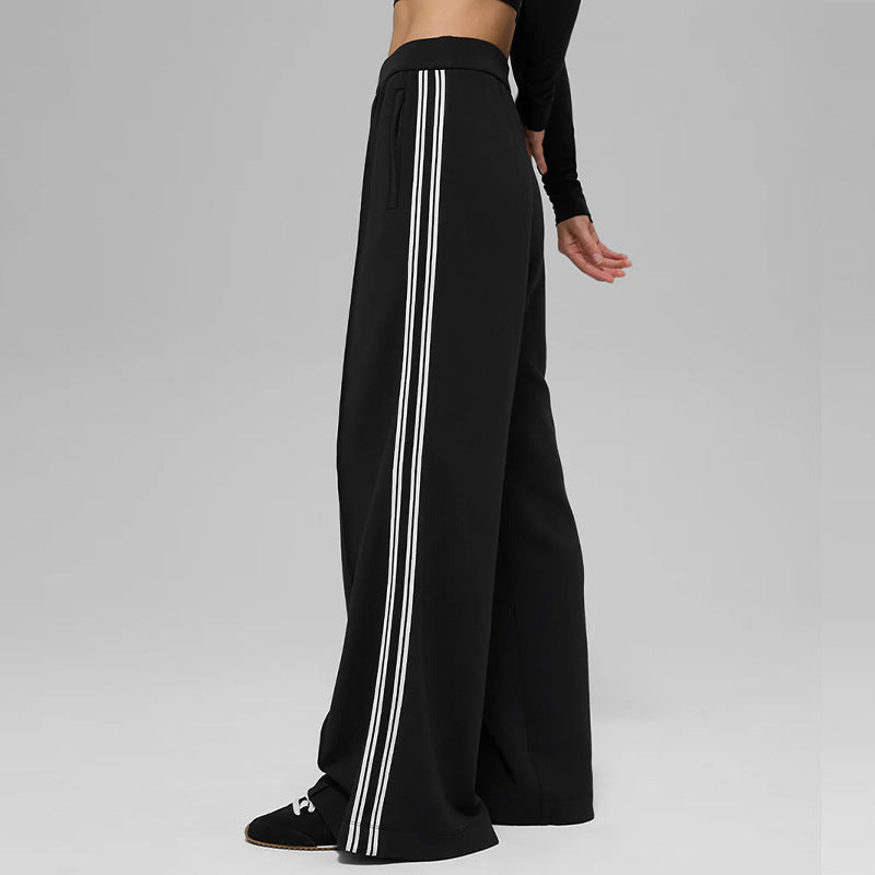 Black wide-leg pants with vertical white stripe panel and elastic waistband