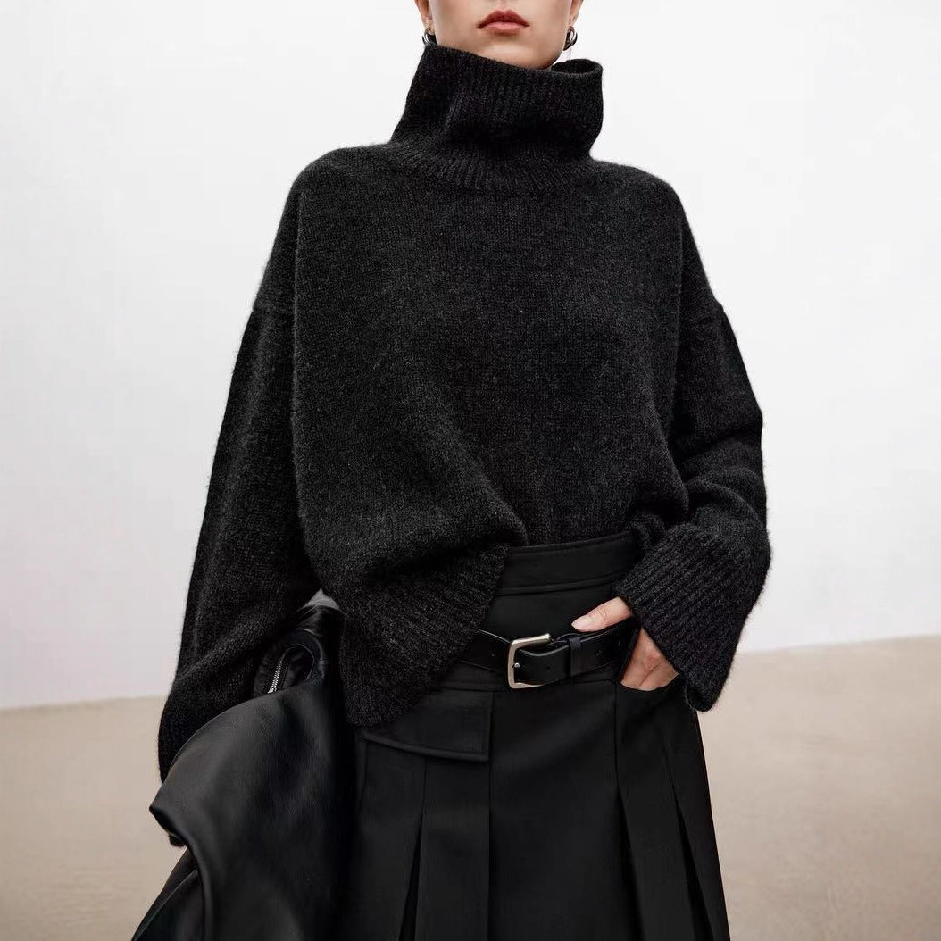 Black knitted turtleneck sweater with long sleeves and ribbed cuffs; loose fit