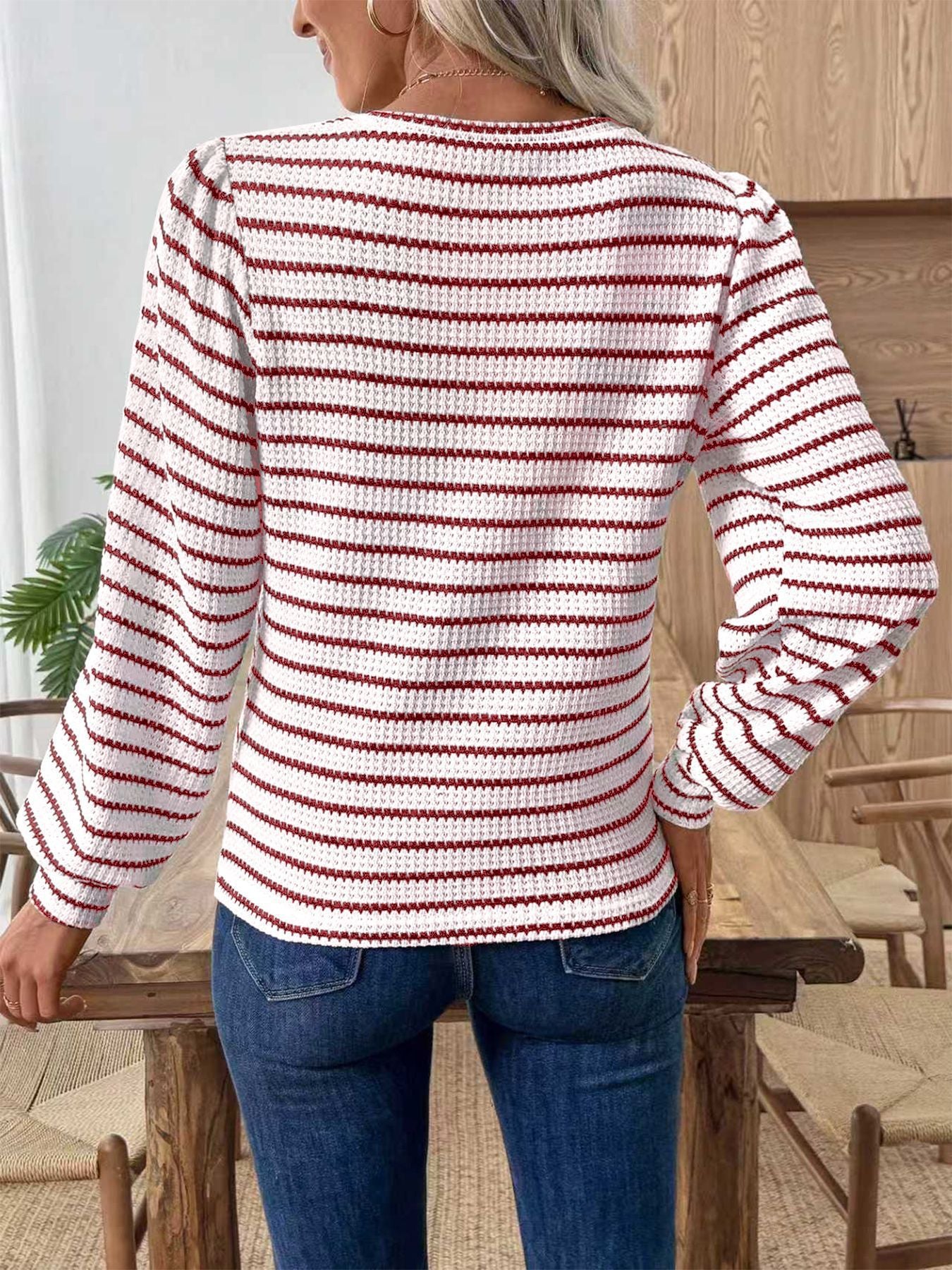 Back view of women’s striped waffle knit crewneck top, red-and-white long sleeves
