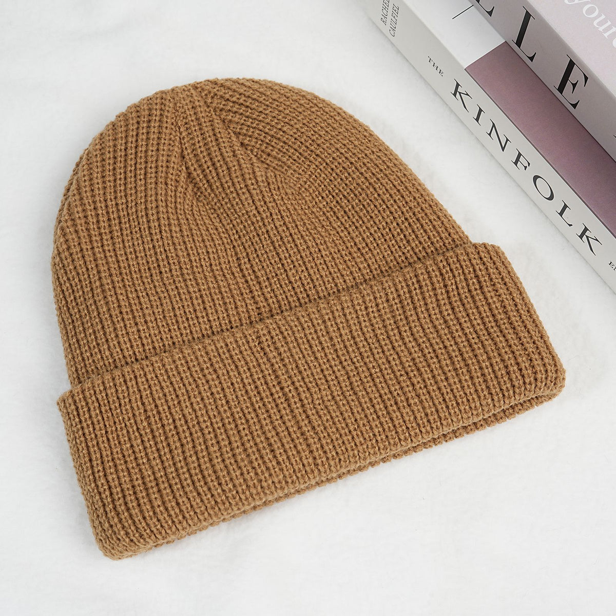 Brown thick ribbed knit beanie hat with folded cuff.