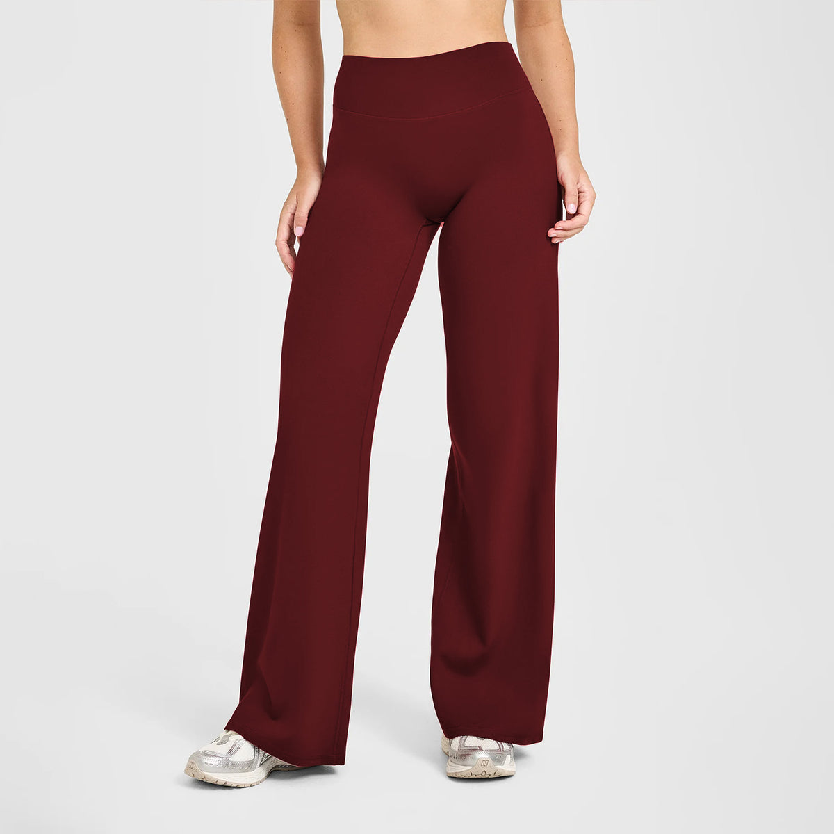 High-waisted straight-leg yoga pants in maroon red, smooth stretch with wide hems