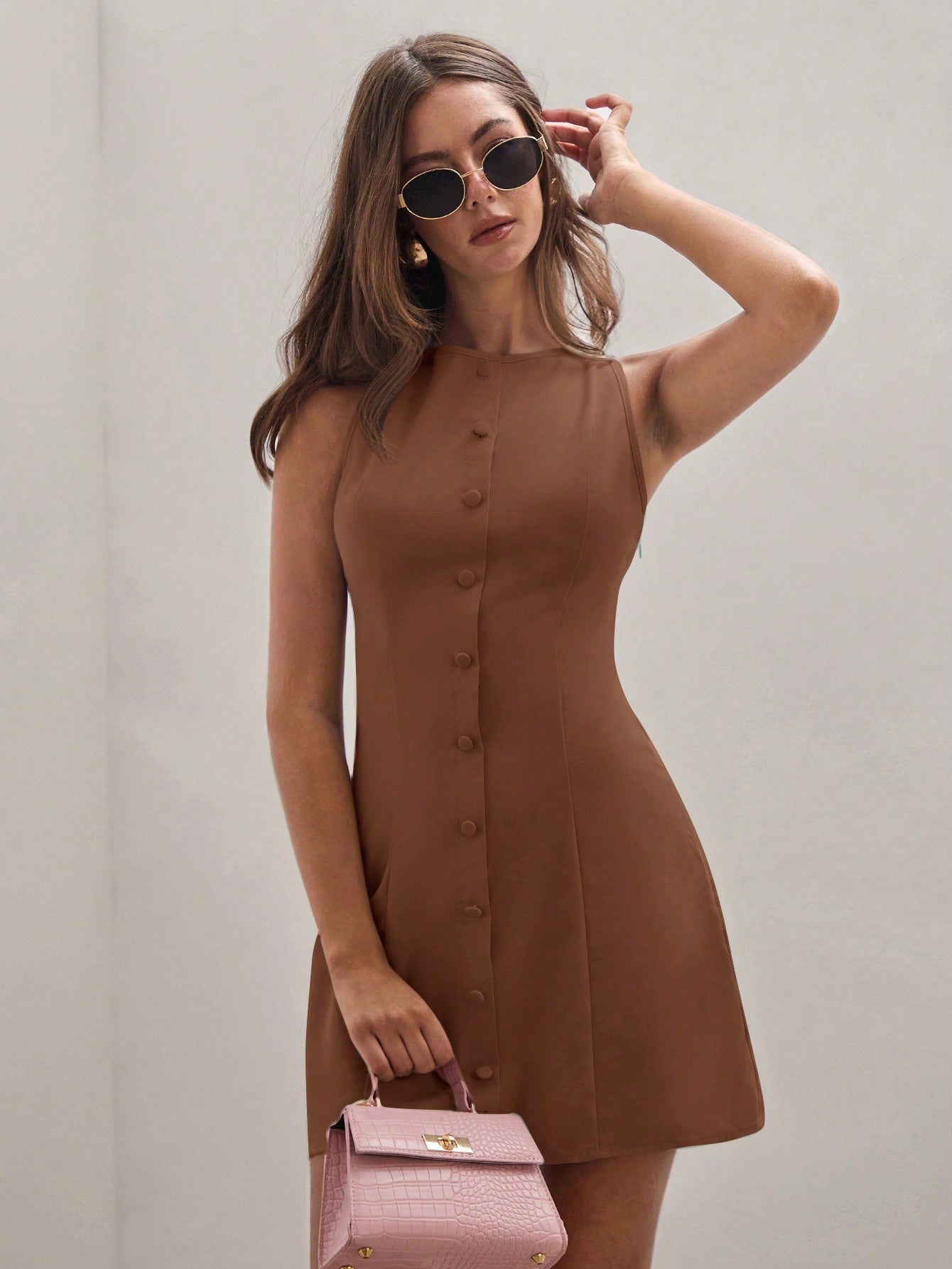 Brown sleeveless shift dress with round neck and button-front mini hem