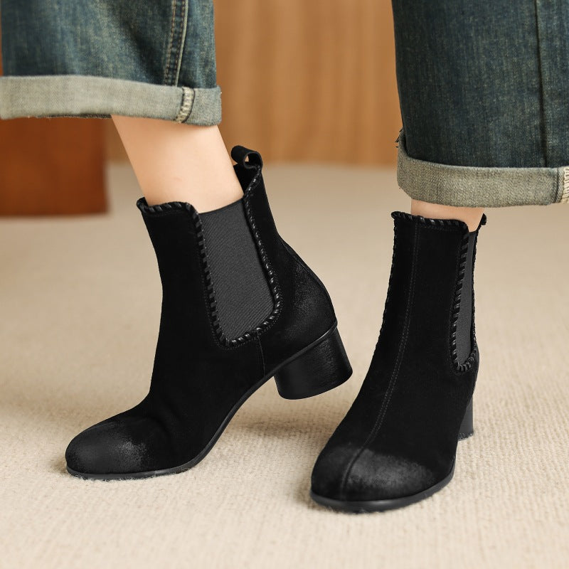 Black suede Chelsea ankle boots with round toe, elastic side panels, chunky heel
