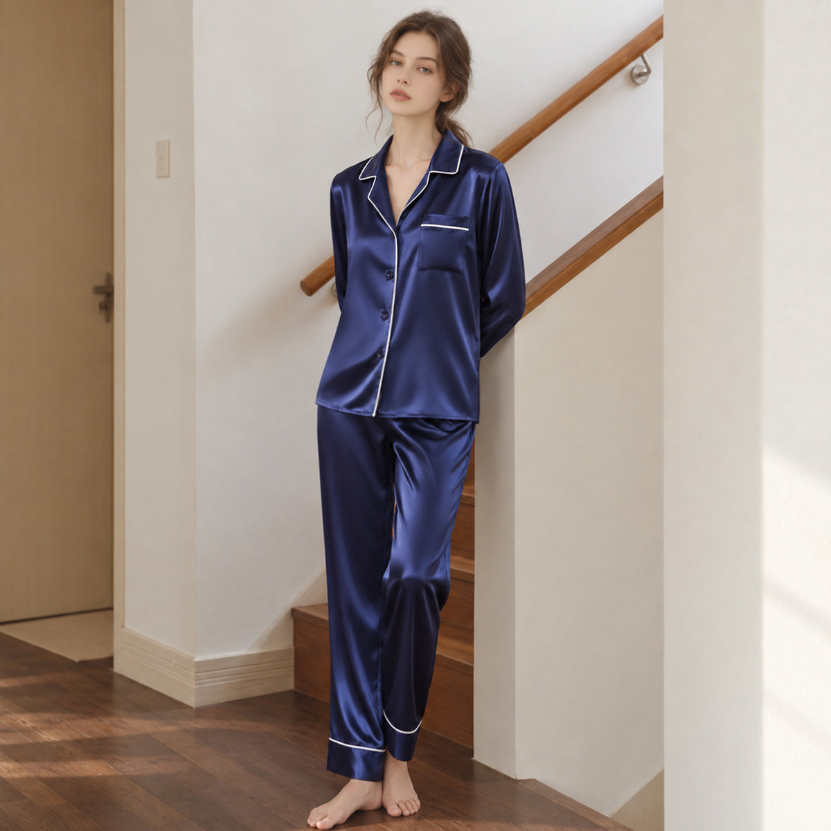 Navy silk pajama set with long-sleeve button-up top and matching long pants, contrast trim