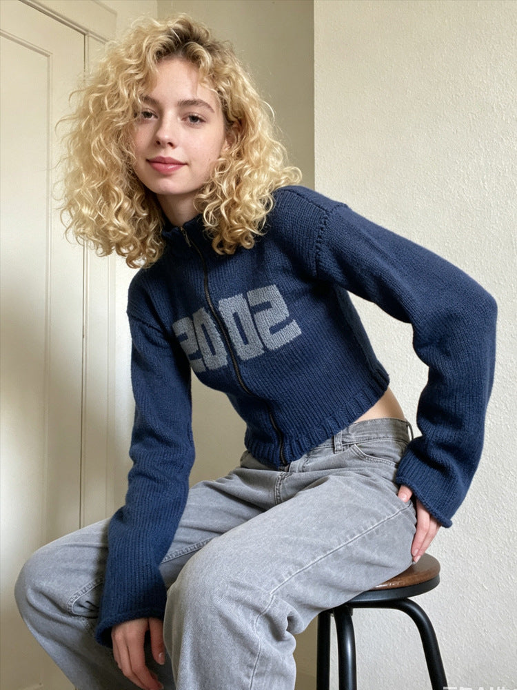Navy-blue cropped knit sweater, half-high collar and front zipper, 2002 logo, bell cuffs
