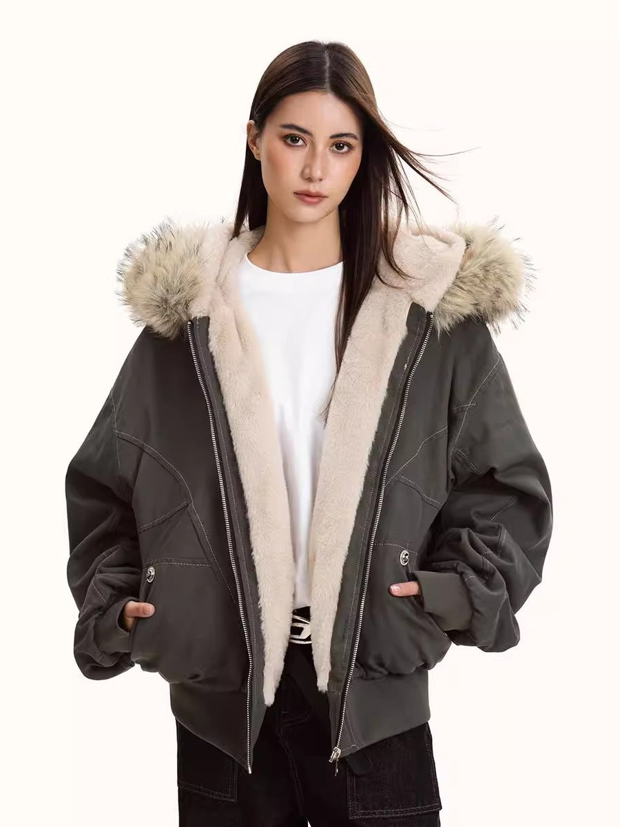 Women’s dark parka jacket with light faux fur hood lining, zip front, and side pockets