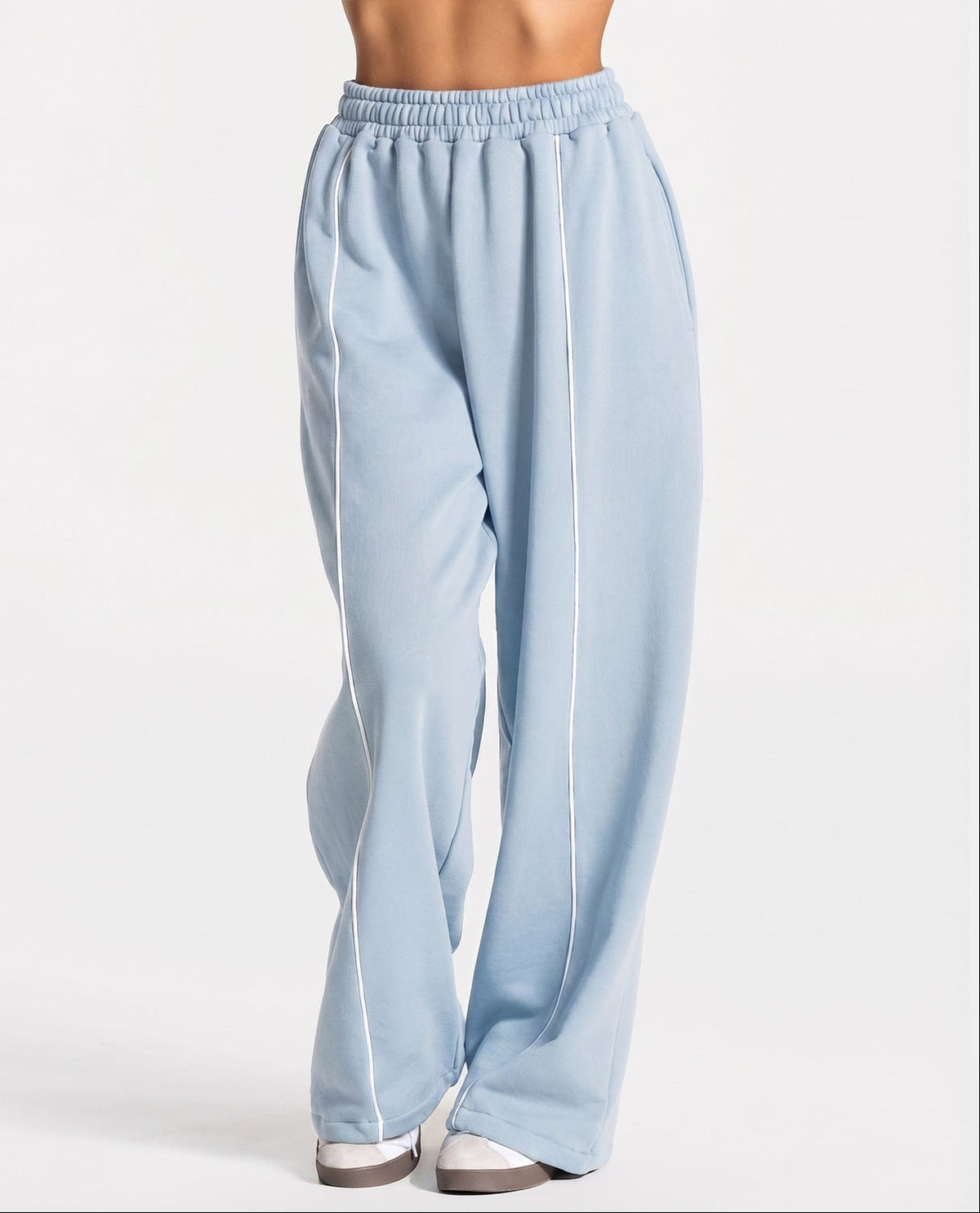 Light blue loose yoga pants with elastic waistband and white contrast stripe