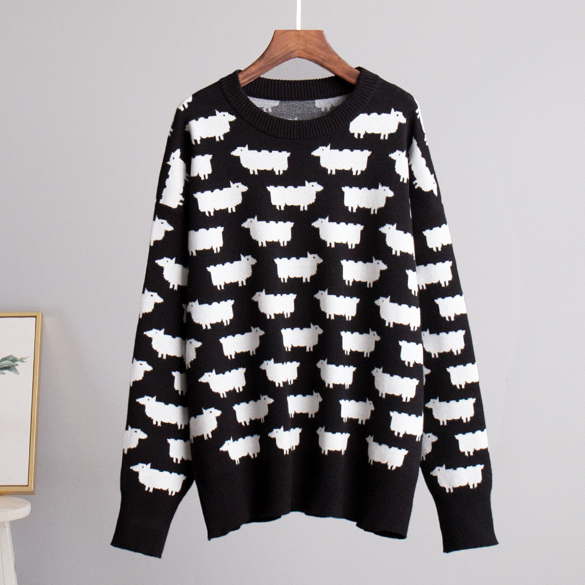 Women’s crewneck knit sweater, black with white sheep pattern, long sleeves
