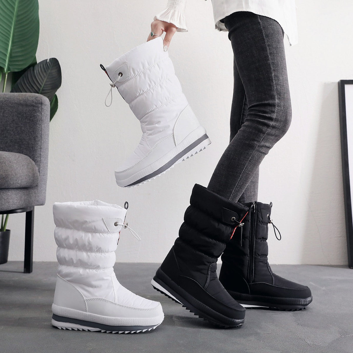 White and black winter snow boots, quilted puffer ankle with lace-up straps.