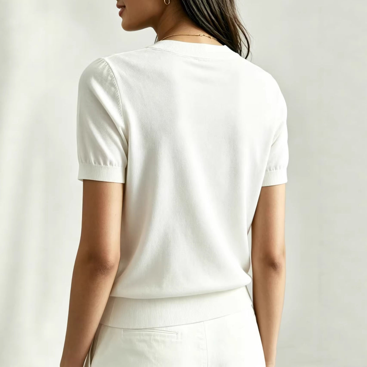 Women's white round-neck t-shirt with short sleeves and ribbed hem, back view